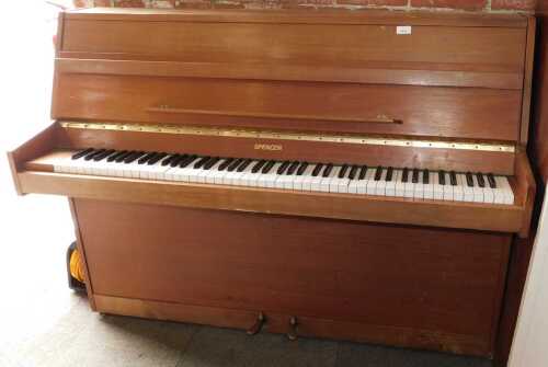 A Wakefield Spencer iron-framed upright piano, with traditional acoustic action and faux ivory...