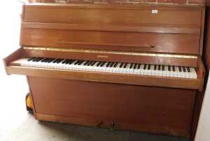 A Wakefield Spencer iron-framed upright piano, with traditional acoustic action and faux ivory...