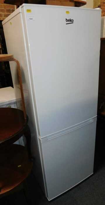 A Beko upright fridge freezer, in white.