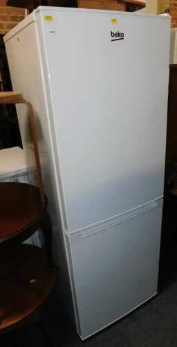 A Beko upright fridge freezer, in white.
