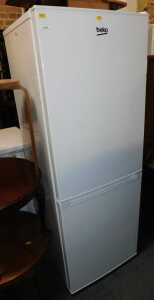 A Beko upright fridge freezer, in white.