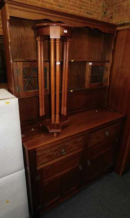 An oak finished dresser with plate rack and two glazed doors, over base unit of two drawers over...