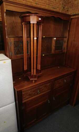 An oak finished dresser with plate rack and two glazed doors, over base unit of two drawers over...