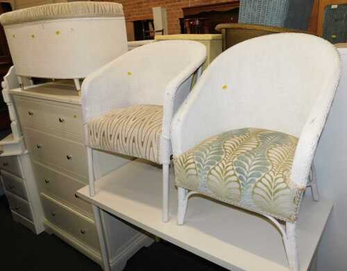 A pair of Lloyd Loom style tub chairs, with cushion seats, and a Lloyd Loom style ottoman with...