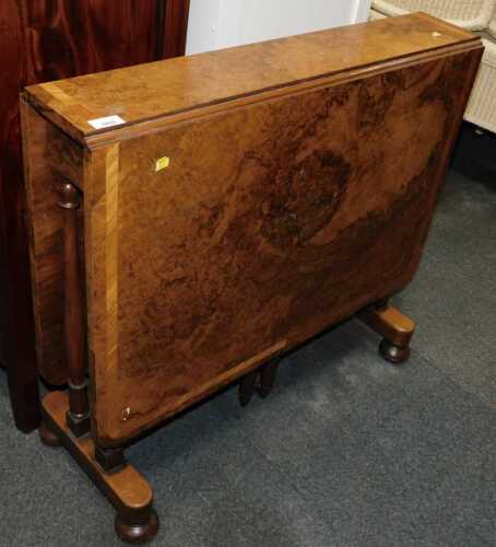 A 19thC walnut and burr walnut Sutherland table, raised on cylindrical turned legs, united by...