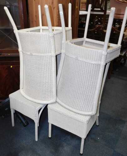 Four Lloyd Loom chairs, bearing plaque.
