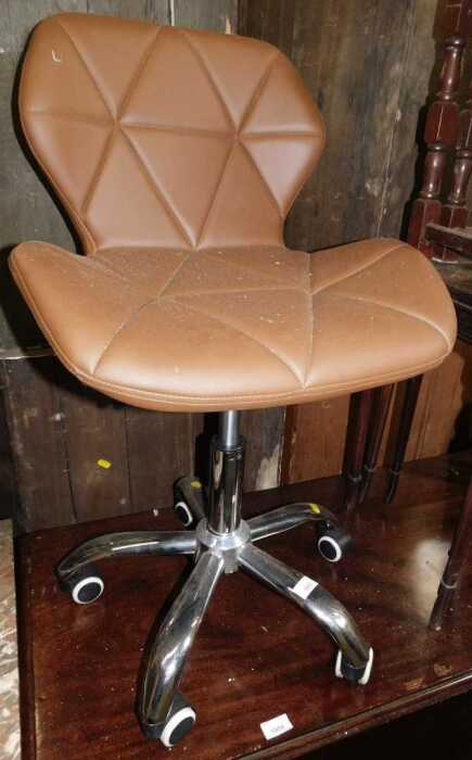 A brown faux leather office chair.