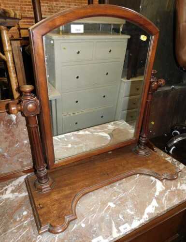 A Victorian mahogany swing frame toilet mirror, the arched mirror on part reeded cylindrical...