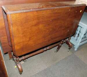 A Victorian mahogany Sutherland table, raised on turned supports, on castors, 71cm high, 91cm wide.