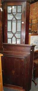 A 19thC oak hanging corner cabinet, the top with a dentil moulded edge, above an astragal glazed...