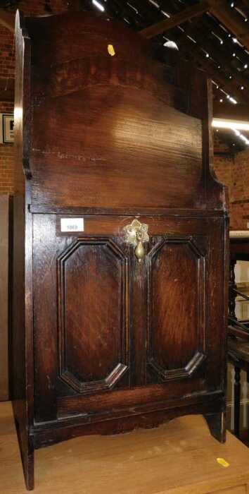 An early 20thC oak magazine rack, with a waterfall top with four recesses, the base with a...