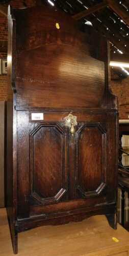 An early 20thC oak magazine rack, with a waterfall top with four recesses, the base with a...