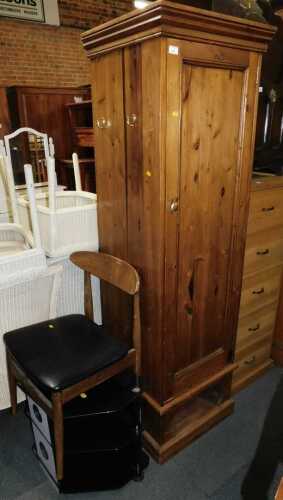 A large pine hall cupboard, with single door opening to reveal clothes rail with hooks to side,...