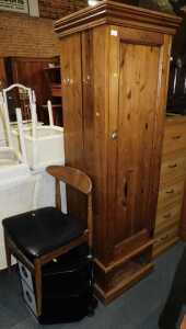 A large pine hall cupboard, with single door opening to reveal clothes rail with hooks to side,...