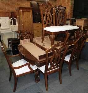 A dining suite, comprising an extending dining table, with three leaves, and eight dining chairs...