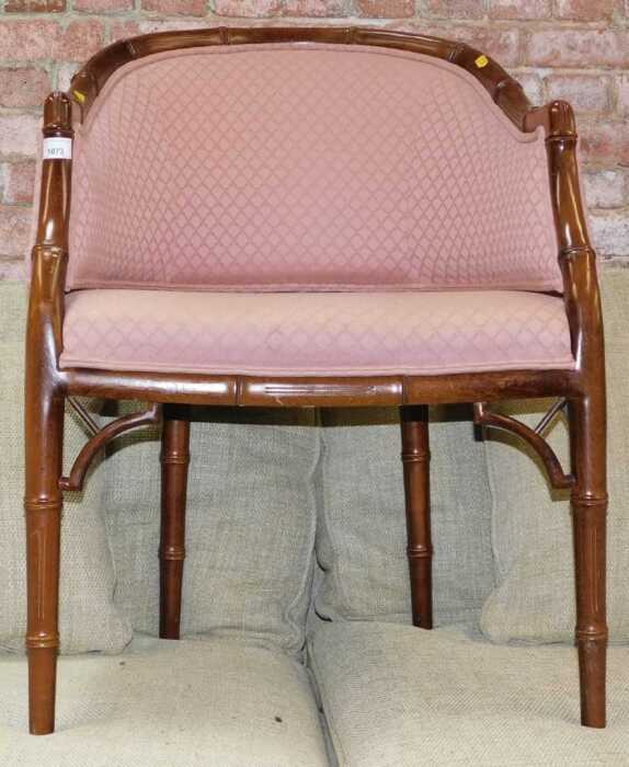 A simulated bamboo finished tub chair, with pink upholstered seat and back.