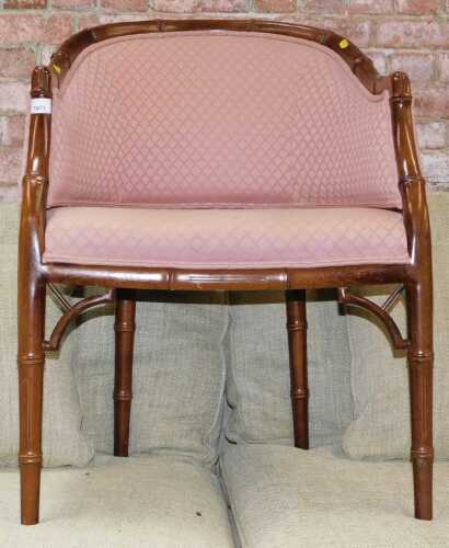 A simulated bamboo finished tub chair, with pink upholstered seat and back.