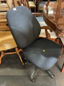 A black finished office chair, with castors below.