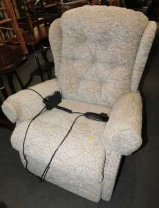 An electric rise and recline armchair, in light brown upholstery.