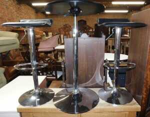 Furniture, comprising two chrome finished bar stools, and a circular chrome finished table.