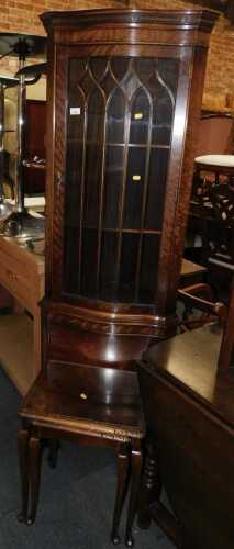 A mahogany veneered corner display cabinet, with glazed top, shelves to interior, panelled door...