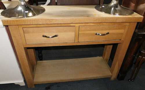 An oak and oak veneered kitchen unit, with two drawers and tier below, raised on square legs.