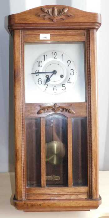An oak wall clock, with Arabic numerals to dial, pendulum, etc.
