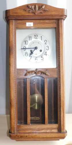 An oak wall clock, with Arabic numerals to dial, pendulum, etc.