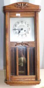 An oak wall clock, with Arabic numerals to dial, pendulum, etc.