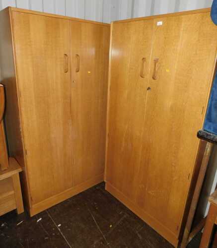 Two G-Plan oak veneered double wardrobes.