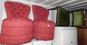 A pair of red upholstered tub nursing chairs, and a single dining chair, Regency style, raised...