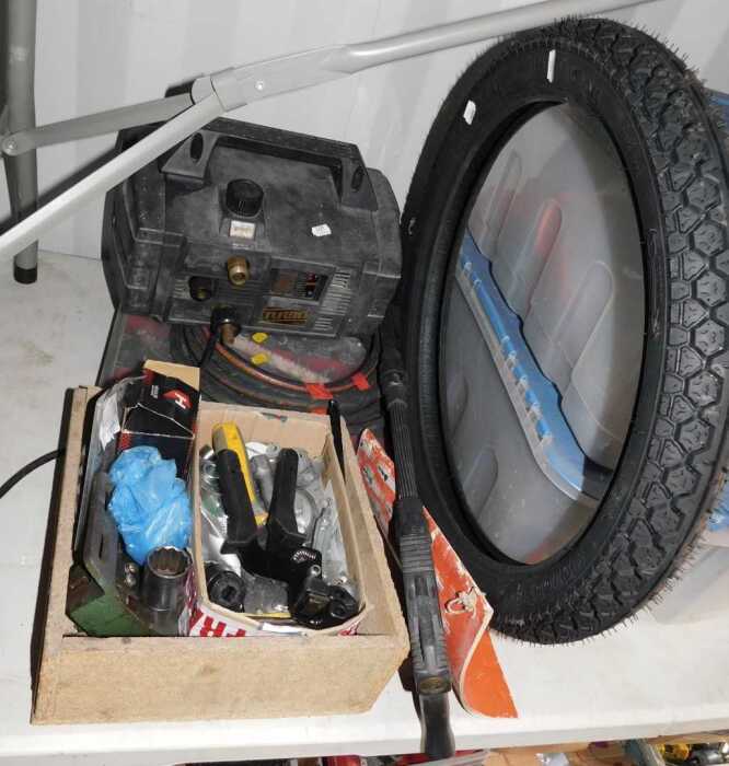 A 2.5x17 tyre, a tray containing engine parts, accessories, etc., a toolbox, another toolbox,...
