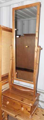 A pine cheval mirror, with drawer below, together with a pine coffee table, raised on turned...