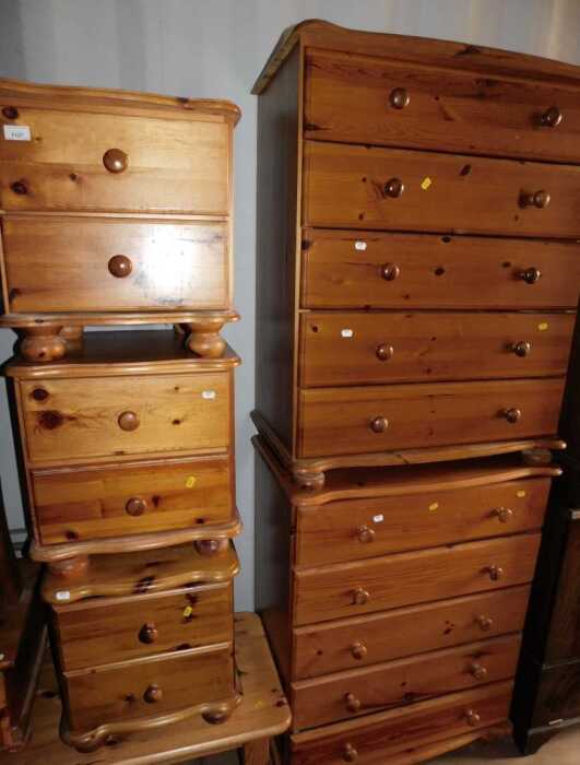 Pine bedroom furniture, comprising three two drawer chests, raised on bun feet, and a pair of...