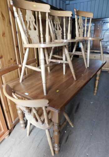 A pine dining table, together with four beech dining chairs. (5)