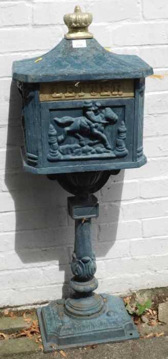 A cast iron letter box, raised on a single column above base unit.