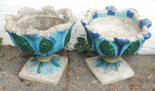 A pair of concrete garden planters, later painted.