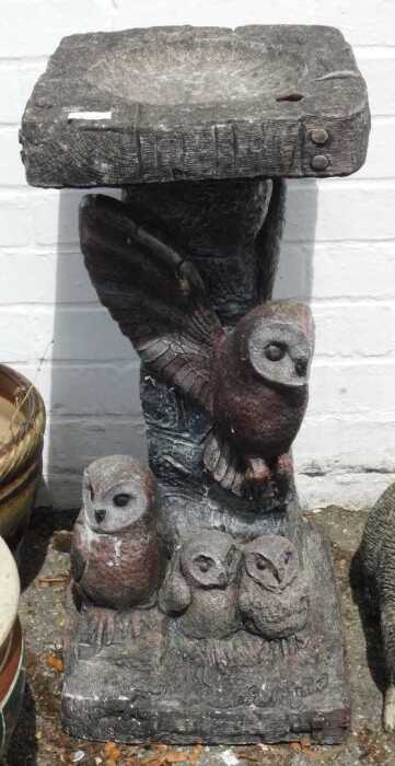 A birdbath, with owls to base.