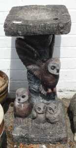A birdbath, with owls to base.