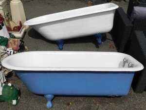 A near pair of cast iron and enamel claw-foot baths, one with taps.
