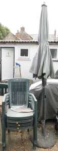 WITHDRAWN PRE SALE BY VENDOR. Four plastic garden chairs, a garden parasol with base.