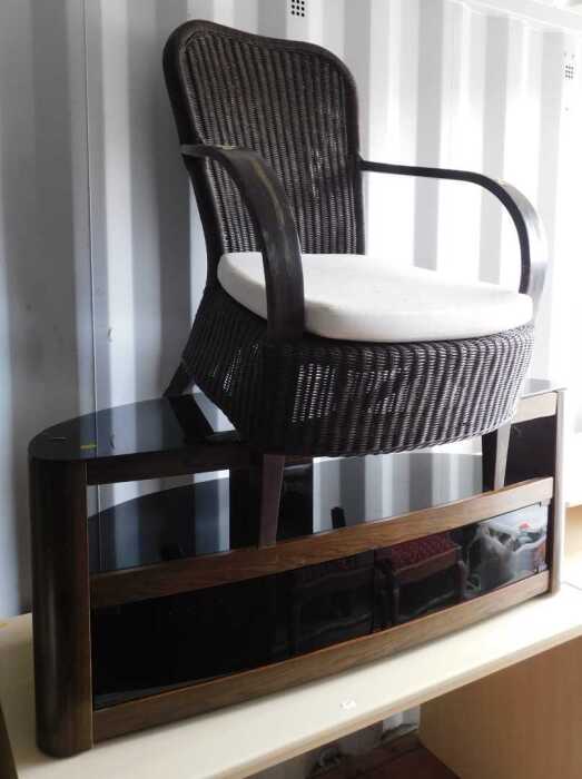 A smoked glass and veneered TV unit, and a conservatory chair, with caned back and seat. (2)