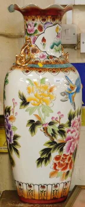 An Oriental style vase, decorated with birds of paradise amongst flowers, 81cm high, 30cm diameter.