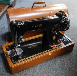 A cased Singer sewing machine.