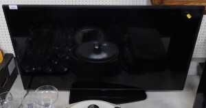 A Samsung flat screen TV, model number QB43Q8CRAT.