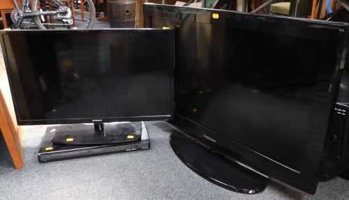 A flat screen TV, model number LE32B450C4W, another smaller, model number SSDV2611-I1, and a...