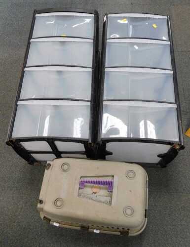 A large plastic four drawer storage cabinet, and a cat travel basket. (contents under 1 table)