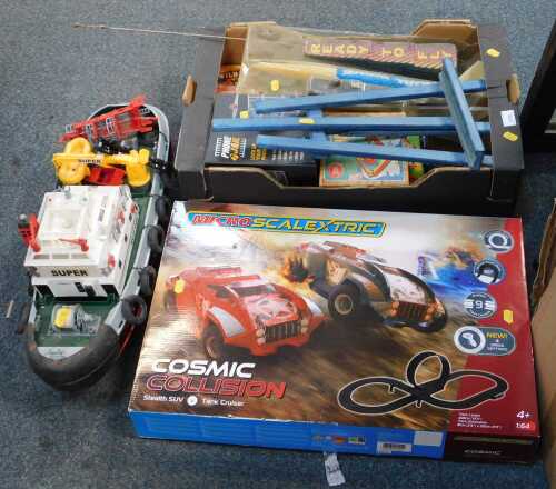 A quantity of boxed toys and games, a Scalextric 1:64 scale Cosmic Collision set, boxed, a tug...