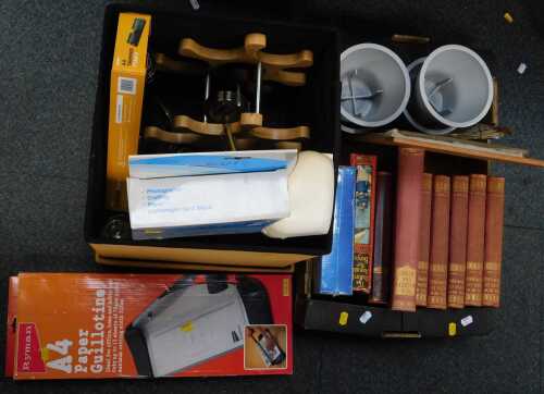 Books and household items, including a storage bin with lid, a portable Maxi Guard trimmer, a...