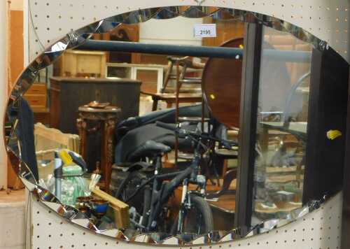 An oval mirror, circa 1950s.